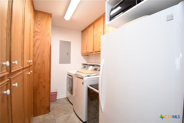 laundry room featuring electric panel, cabinets, and independent washer and dryer