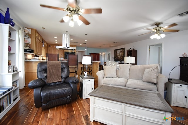 living room with dark wood-type flooring and ceiling fan