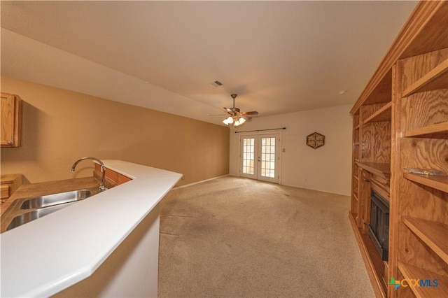 3259 Wren Brook Dr, New Braunfels, TX 78130 - living room with ceiling fan, french doors, light carpet, and a large fireplace