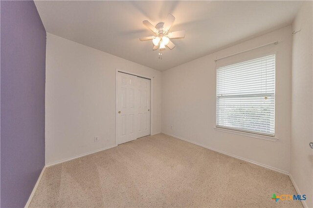 3259 Wren Brook Dr, New Braunfels, TX 78130 - unfurnished bedroom featuring light colored carpet, baseboards, a closet, and a ceiling fan
