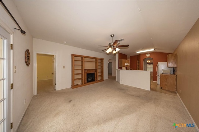 3259 Wren Brook Dr, New Braunfels, TX 78130 - unfurnished living room with a ceiling fan, a fireplace with raised hearth, light colored carpet, and vaulted ceiling