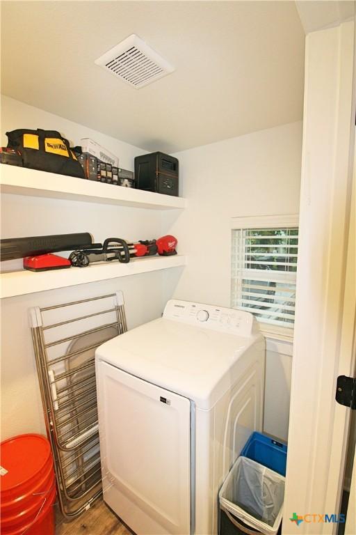 921 N 10th St, Temple, TX 76501 - laundry area featuring washer / clothes dryer and wood finished floors