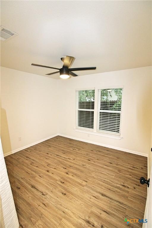 921 N 10th St, Temple, TX 76501 - spare room featuring wood finished floors and a ceiling fan