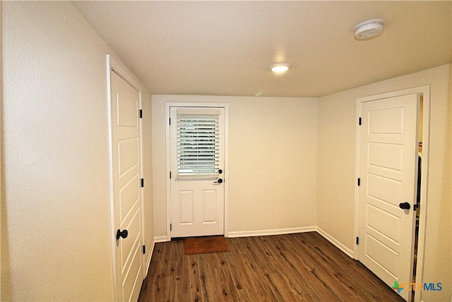 921 N 10th St, Temple, TX 76501 - doorway with dark wood finished floors and baseboards