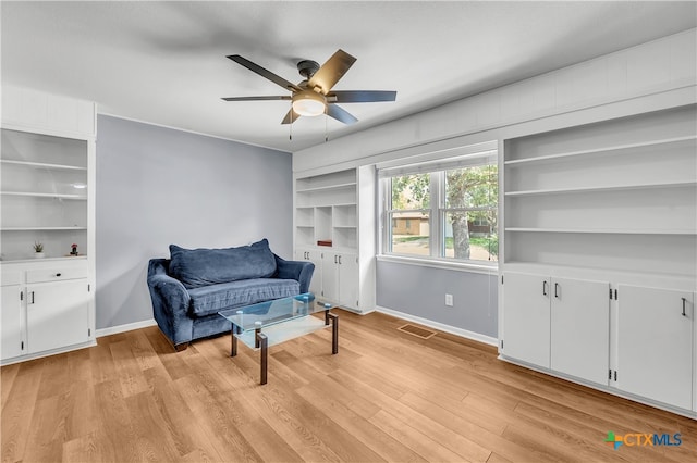 living area featuring ceiling fan and light hardwood / wood-style floors