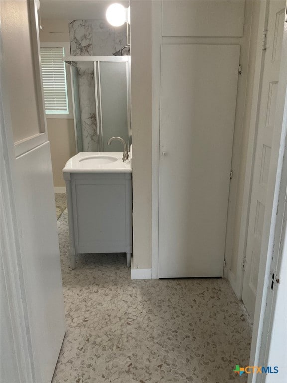 bathroom featuring an enclosed shower and vanity