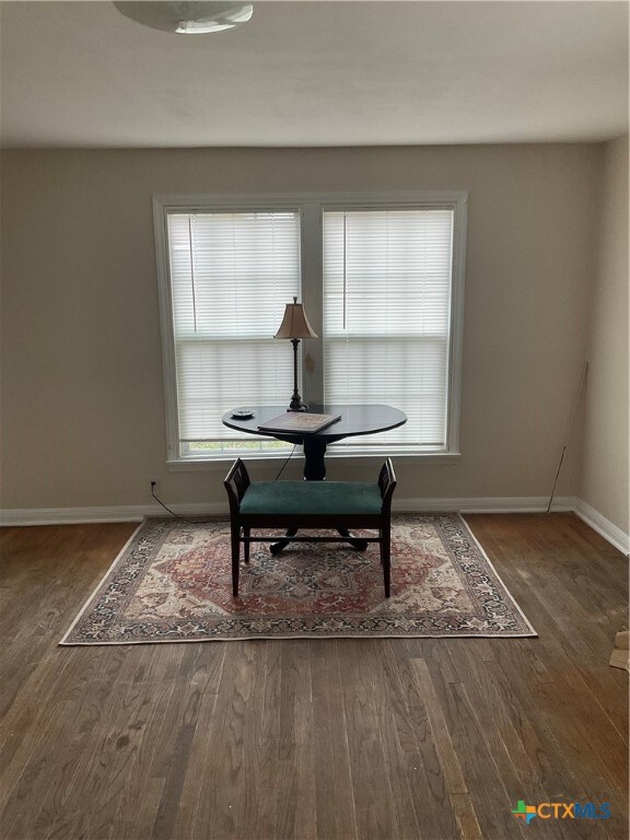 dining area with dark hardwood / wood-style flooring and a healthy amount of sunlight