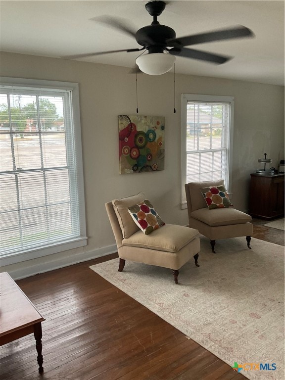 sitting room featuring dark hardwood / wood-style flooring and ceiling fan