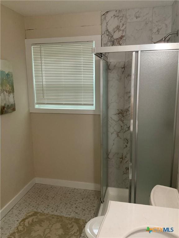 111 N 11th St, Temple, TX 76501 - bathroom with toilet, a stall shower, baseboards, and vanity