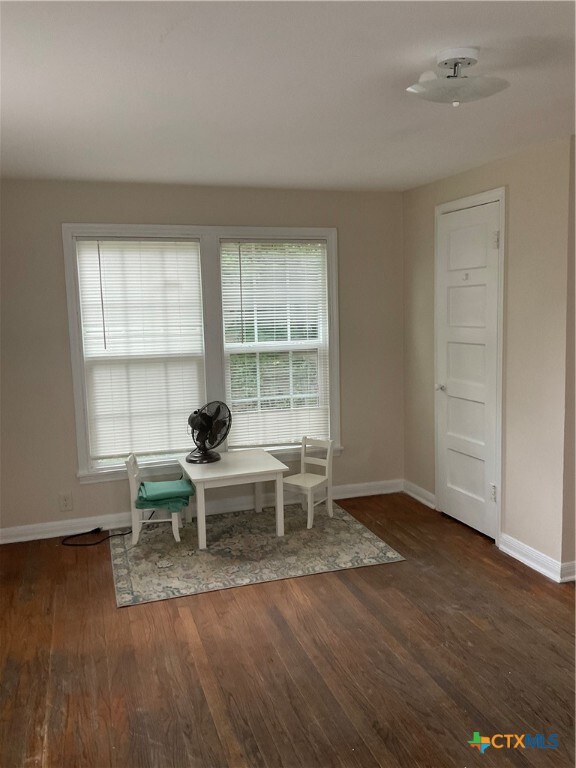 unfurnished dining area with dark hardwood / wood-style flooring