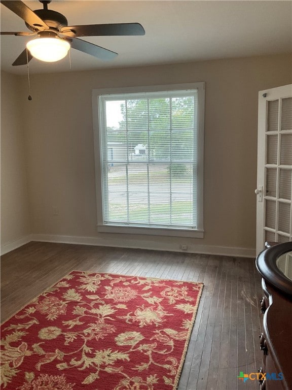 interior space featuring ceiling fan and dark hardwood / wood-style floors