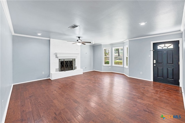 unfurnished living room featuring ornamental molding, a fireplace, hardwood / wood-style flooring, and ceiling fan