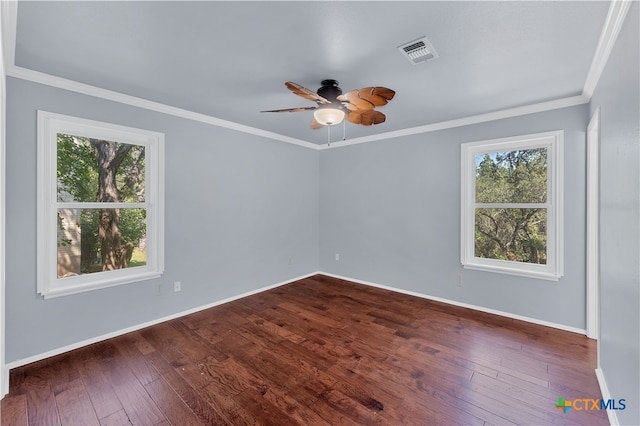 spare room featuring dark wood-type flooring, ceiling fan, and crown molding