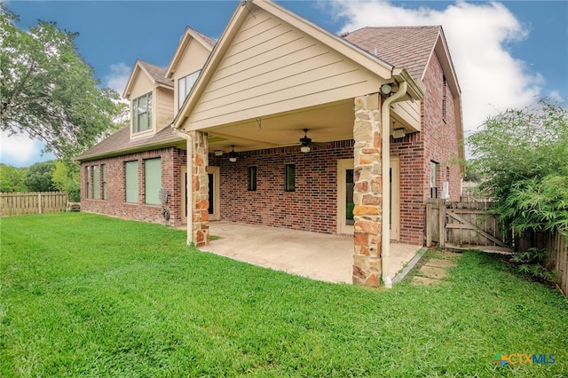 back of property with ceiling fan, a patio area, and a lawn