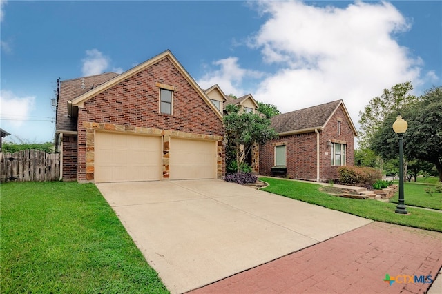 26 Cotswold Ln, Victoria, TX 77904 - traditional home with brick siding, driveway, and a garage