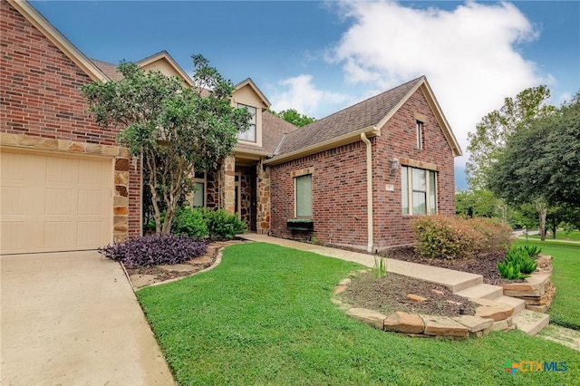 front facade featuring a garage and a front lawn