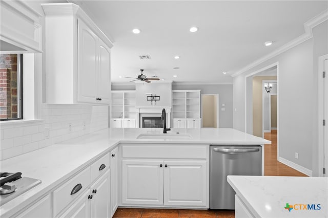 kitchen featuring kitchen peninsula, stainless steel dishwasher, ceiling fan, sink, and white cabinetry