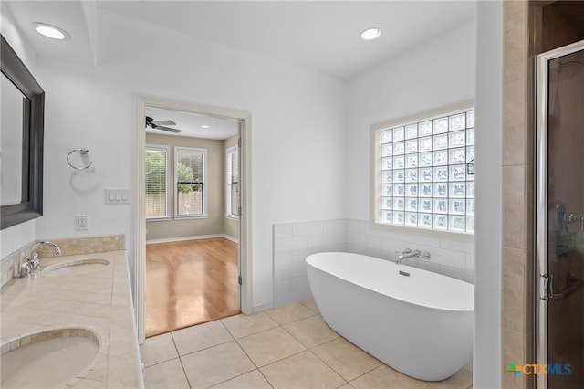 bathroom with tile patterned floors, ceiling fan, vanity, and independent shower and bath