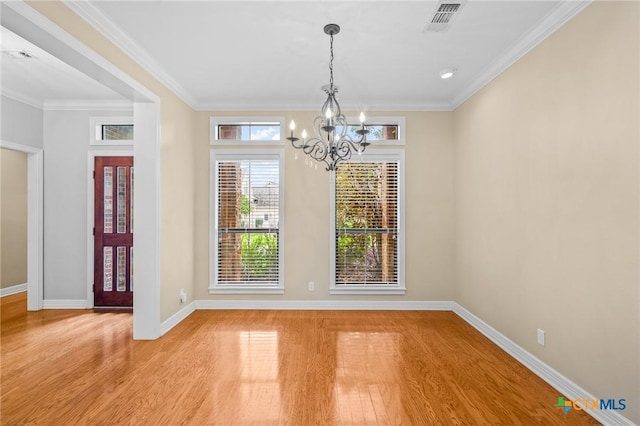 26 Cotswold Ln, Victoria, TX 77904 - unfurnished dining area with a chandelier, light wood-style floors, and ornamental molding