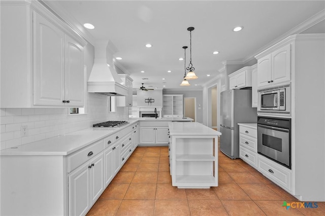 26 Cotswold Ln, Victoria, TX 77904 - kitchen with stainless steel appliances, open shelves, custom exhaust hood, light tile patterned floors, and recessed lighting