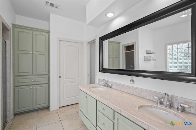 26 Cotswold Ln, Victoria, TX 77904 - bathroom featuring double vanity, tile patterned floors, a stall shower, and backsplash