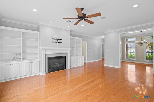 unfurnished living room featuring ceiling fan with notable chandelier, light wood-type flooring, and crown molding