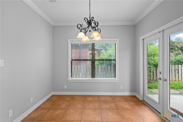 26 Cotswold Ln, Victoria, TX 77904 - unfurnished dining area with a chandelier, light tile patterned floors, and crown molding