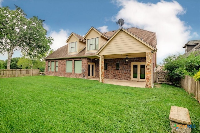 26 Cotswold Ln, Victoria, TX 77904 - rear view of property featuring french doors, a fenced backyard, brick siding, and a patio