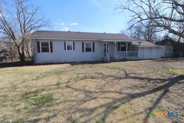 ranch-style home with covered porch and a front lawn