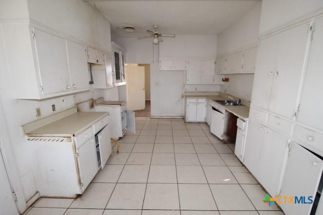 kitchen featuring light tile patterned flooring, ceiling fan, a sink, and white cabinetry