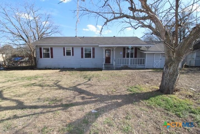 ranch-style home with covered porch and a front yard