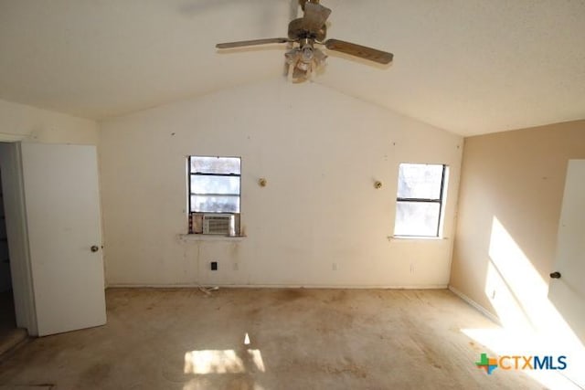 spare room with lofted ceiling, plenty of natural light, cooling unit, and a ceiling fan