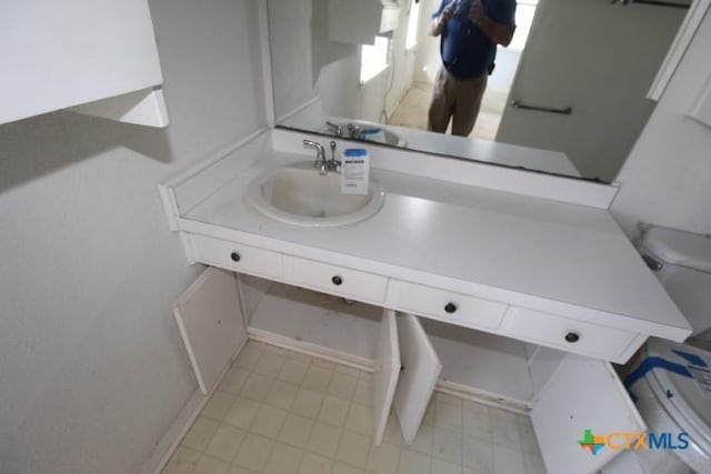 bathroom with vanity, toilet, and tile patterned floors