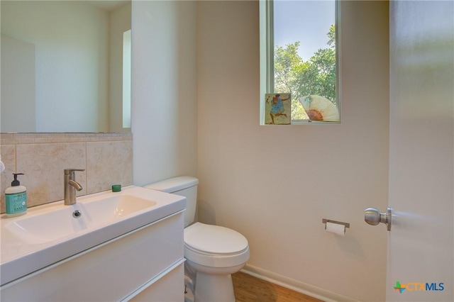 1550 Moon View Dr, New Braunfels, TX 78132 - half bath with tasteful backsplash, baseboards, toilet, wood finished floors, and vanity