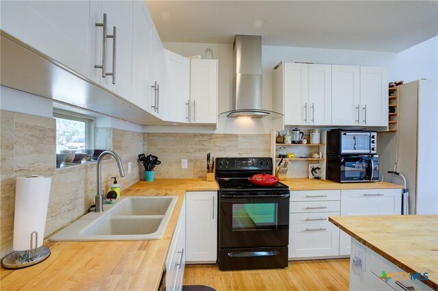 1550 Moon View Dr, New Braunfels, TX 78132 - kitchen featuring black appliances, butcher block countertops, a sink, open shelves, and wall chimney range hood