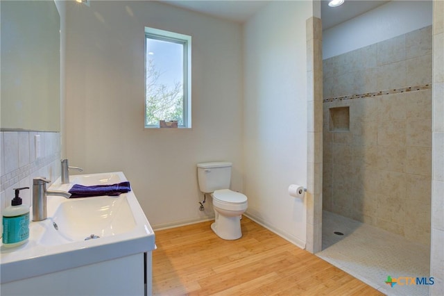 1550 Moon View Dr, New Braunfels, TX 78132 - bathroom with walk in shower, toilet, double vanity, wood finished floors, and a sink