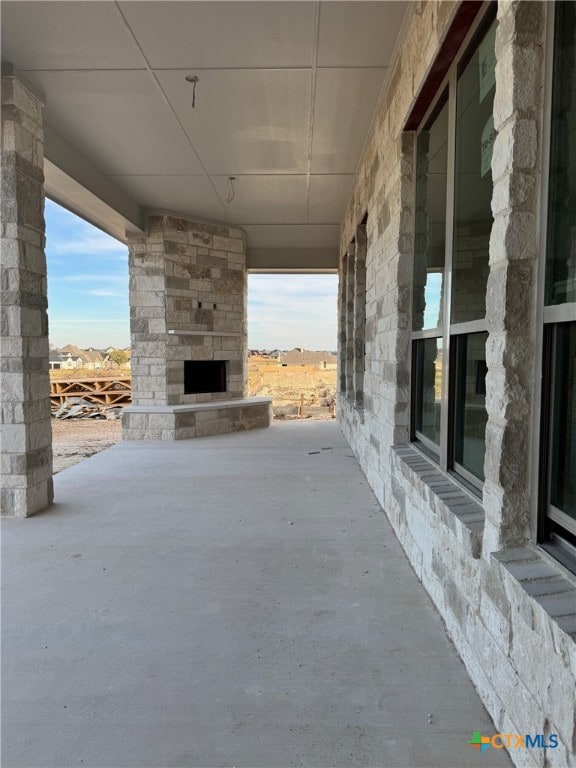 view of patio / terrace with an outdoor stone fireplace