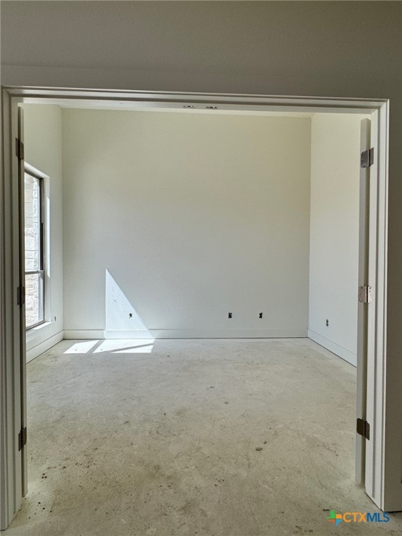 empty room with unfinished concrete floors