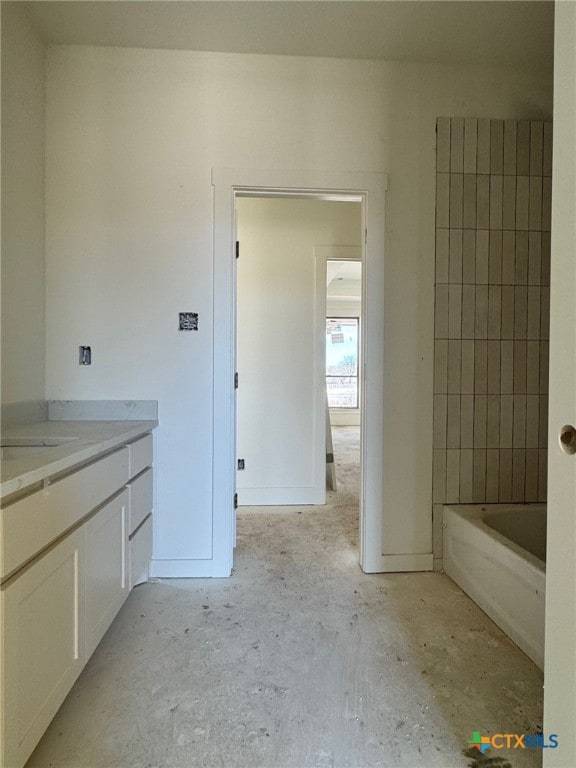 bathroom featuring vanity and a tub