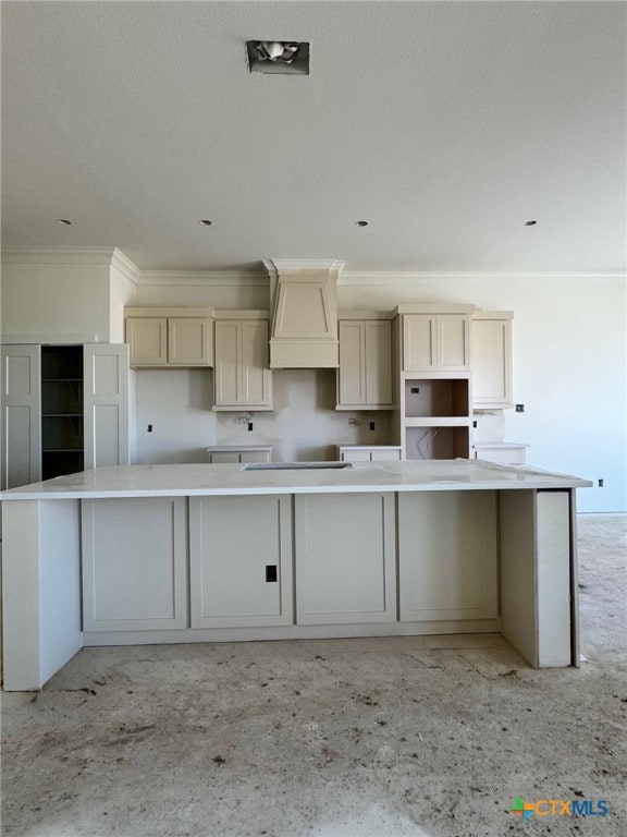 kitchen with a spacious island, ornamental molding, black electric stovetop, custom exhaust hood, and fridge