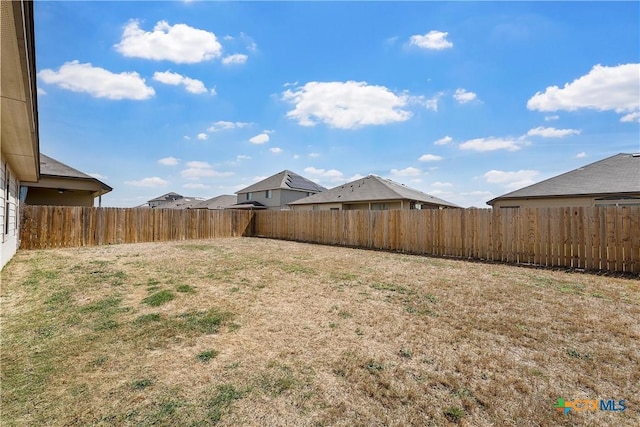 view of yard with a fenced backyard