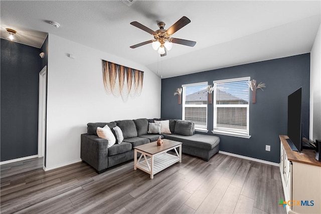 living area featuring baseboards, wood finished floors, and a ceiling fan