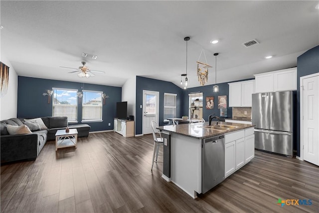 kitchen with visible vents, a sink, open floor plan, dark wood-style floors, and stainless steel appliances