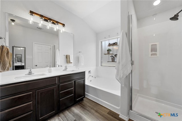 bathroom with a stall shower and a sink