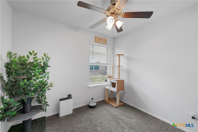 empty room with ceiling fan, baseboards, and carpet