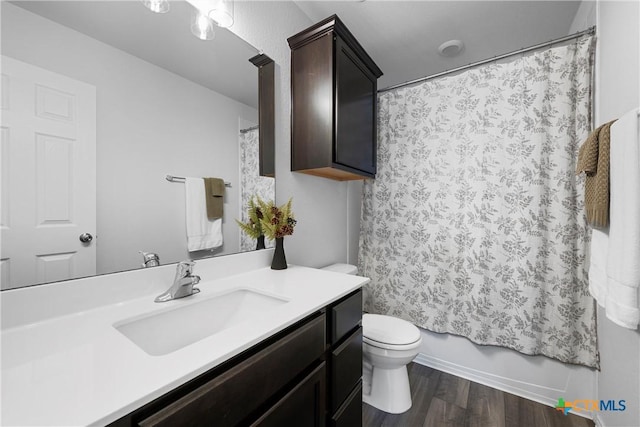 full bathroom with toilet, wood finished floors, vanity, and shower / bath combination with curtain