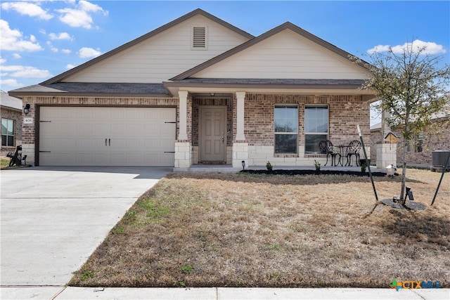 view of front of home featuring central air condition unit, driveway, a porch, a garage, and brick siding