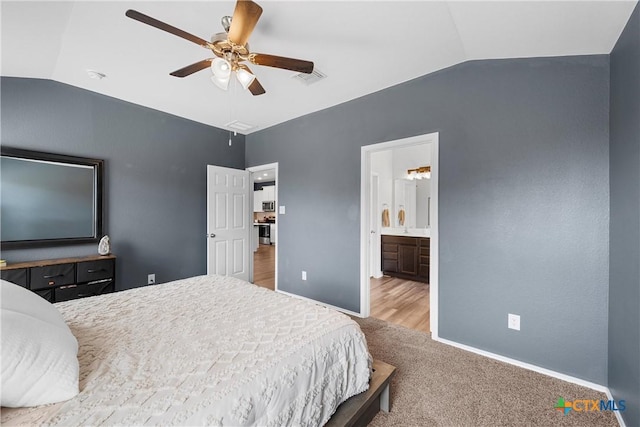 carpeted bedroom featuring visible vents, lofted ceiling, baseboards, and a ceiling fan