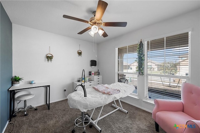 carpeted office with baseboards and ceiling fan