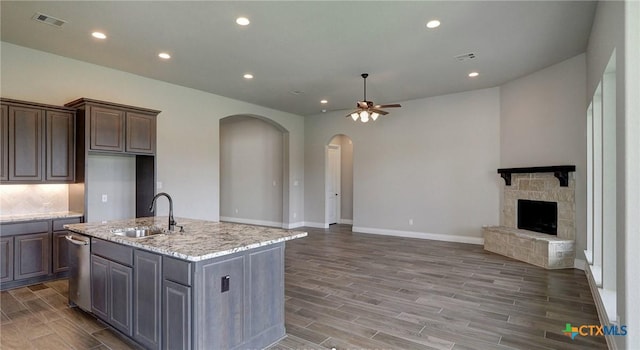 633 Vale Ct, New Braunfels, TX 78132 - kitchen with a sink, arched walkways, ceiling fan, open floor plan, and dishwasher